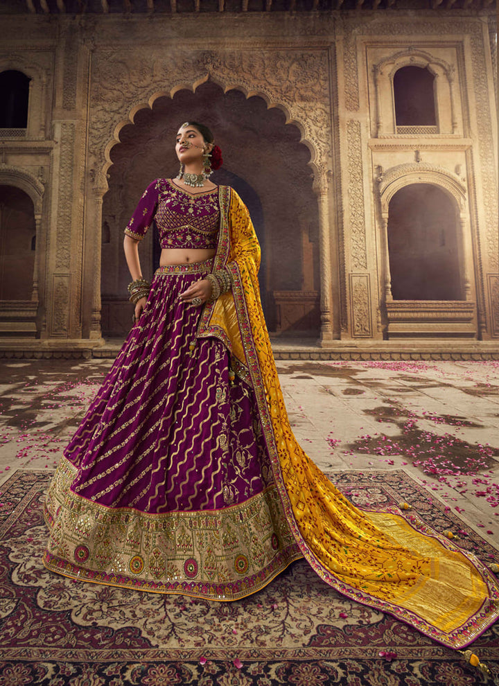 Image: Women in Purple Wine Designer Wedding Wear Lehenga Choli with Weaving Work. The lehenga choli features a rich and elegant purple wine color, accentuated with intricate weaving work. The weaving patterns add depth and texture to the ensemble, creating a captivating and luxurious look. This attire is perfect for a wedding or special occasion, emanating sophistication and glamour.