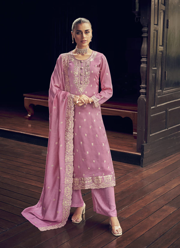 Image: Woman in Pink Color Elegance Redefined Party Wear Straight Salwar Suits. This beautiful ensemble features a charming pink color, designed for elegance and sophistication. The straight salwar suit is the epitome of grace, making it a perfect choice for parties and special occasions. With its refined design and stunning color, this outfit is sure to redefine elegance and captivate everyone's attention.