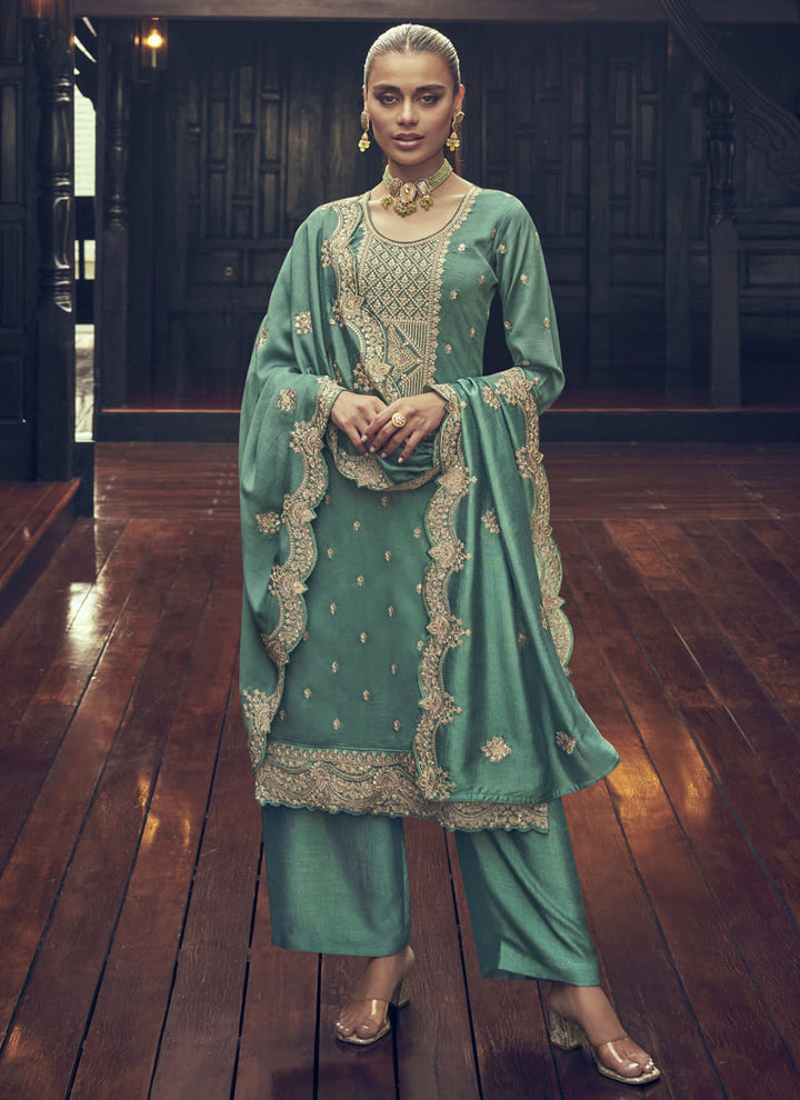 Image: Woman in Green Color Elegance Redefined Party Wear Straight Salwar Suits. This beautiful ensemble features a charming pink color, designed for elegance and sophistication. The straight salwar suit is the epitome of grace, making it a perfect choice for parties and special occasions. With its refined design and stunning color, this outfit is sure to redefine elegance and captivate everyone's attention.