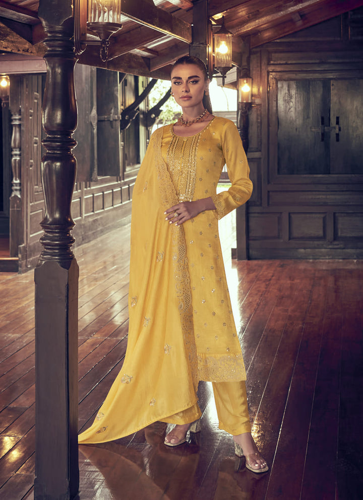 Image: Woman in Yellow Color Elegance Redefined Party Wear Straight Salwar Suits. This beautiful ensemble features a charming pink color, designed for elegance and sophistication. The straight salwar suit is the epitome of grace, making it a perfect choice for parties and special occasions. With its refined design and stunning color, this outfit is sure to redefine elegance and captivate everyone's attention.