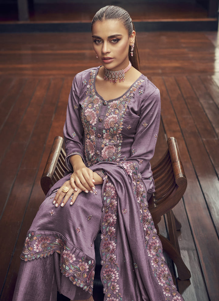 Image: Woman in Lavender Color Elegance Redefined Party Wear Straight Salwar Suits. This beautiful ensemble features a charming pink color, designed for elegance and sophistication. The straight salwar suit is the epitome of grace, making it a perfect choice for parties and special occasions. With its refined design and stunning color, this outfit is sure to redefine elegance and captivate everyone's attention.