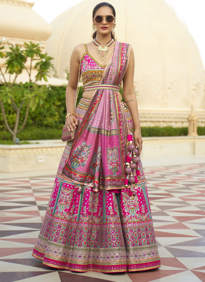 Image: Women in Deep Pink Radiant Smooth Rajwadi Silk Lehenga Choli. This mesmerizing ensemble showcases a radiant and smooth texture, made from luxurious Rajwadi silk. The lehenga choli exudes elegance and charm, perfect for special occasions and weddings. With its exquisite craftsmanship and glamorous appeal, this outfit is sure to make the wearer stand out with sophistication and style.