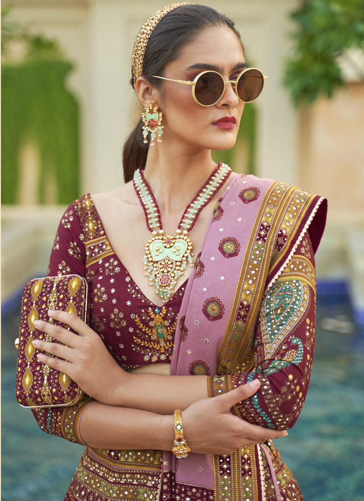 Image: Women in Ruby Pink Radiant Smooth Rajwadi Silk Lehenga Choli. This mesmerizing ensemble showcases a radiant and smooth texture, made from luxurious Rajwadi silk. The lehenga choli exudes elegance and charm, perfect for special occasions and weddings. With its exquisite craftsmanship and glamorous appeal, this outfit is sure to make the wearer stand out with sophistication and style.