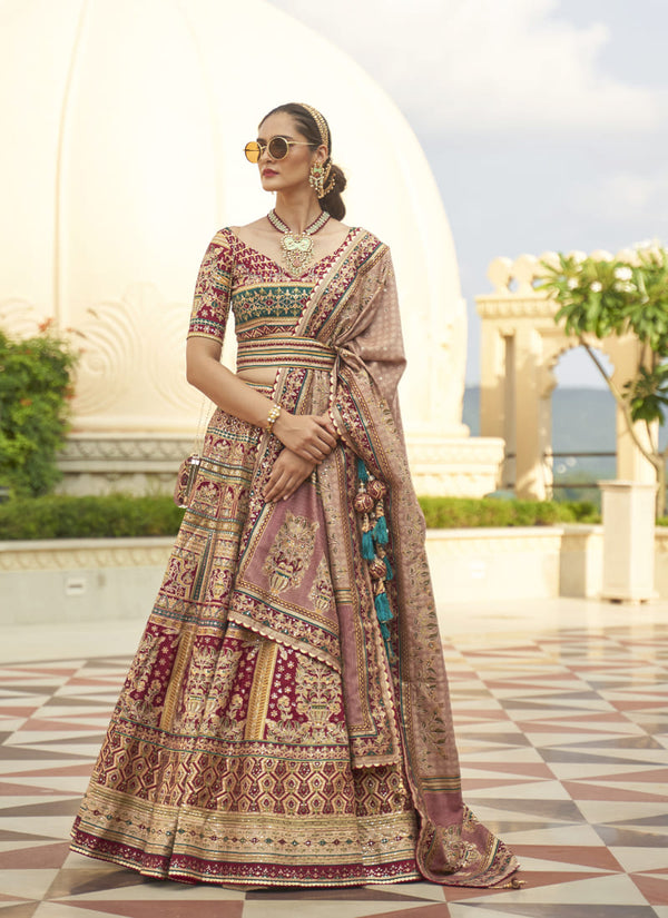 Image: Women in Maroon Radiant Smooth Rajwadi Silk Lehenga Choli. This mesmerizing ensemble showcases a radiant and smooth texture, made from luxurious Rajwadi silk. The lehenga choli exudes elegance and charm, perfect for special occasions and weddings. With its exquisite craftsmanship and glamorous appeal, this outfit is sure to make the wearer stand out with sophistication and style.